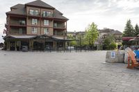 a blue chair is set on the square with the buildings behind it in front of them