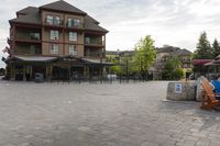 a blue chair is set on the square with the buildings behind it in front of them