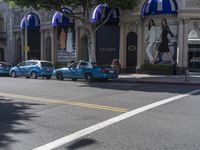 people are walking down the road near a store with blue and white awnings