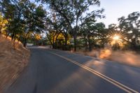 a blurry image of a highway surrounded by trees and a grass field with trees on either side