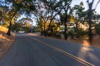 a blurry image of a highway surrounded by trees and a grass field with trees on either side