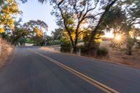 a blurry image of a highway surrounded by trees and a grass field with trees on either side