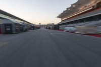 a blurry image of a bus moving in the distance near a terminal by itself