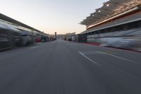 a blurry image of a bus moving in the distance near a terminal by itself