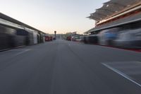 a blurry image of a bus moving in the distance near a terminal by itself