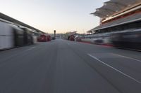 a blurry image of a bus moving in the distance near a terminal by itself