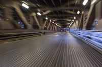 an image of a blurred pedestrian walkway in the night time with focus on the lights