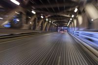 an image of a blurred pedestrian walkway in the night time with focus on the lights