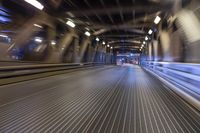 an image of a blurred pedestrian walkway in the night time with focus on the lights