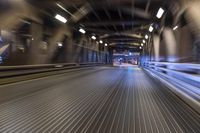 an image of a blurred pedestrian walkway in the night time with focus on the lights