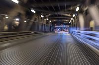 an image of a blurred pedestrian walkway in the night time with focus on the lights