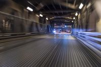 an image of a blurred pedestrian walkway in the night time with focus on the lights