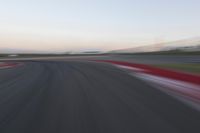 an abstract blurry photo of the racing track in action at dusk - img - 637