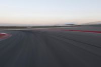 an abstract blurry photo of the racing track in action at dusk - img - 637