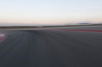 an abstract blurry photo of the racing track in action at dusk - img - 637