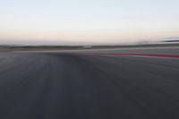 an abstract blurry photo of the racing track in action at dusk - img - 637