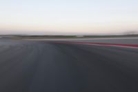 an abstract blurry photo of the racing track in action at dusk - img - 637