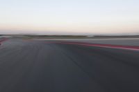 an abstract blurry photo of the racing track in action at dusk - img - 637