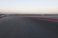 an abstract blurry photo of the racing track in action at dusk - img - 637