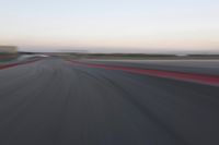 an abstract blurry photo of the racing track in action at dusk - img - 637