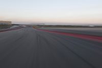 an abstract blurry photo of the racing track in action at dusk - img - 637