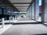 blurred photograph of a train station with cars moving by at high speed and blurry