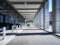 blurred photograph of a train station with cars moving by at high speed and blurry