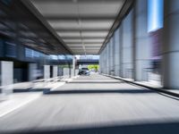 blurred photograph of a train station with cars moving by at high speed and blurry