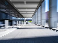 blurred photograph of a train station with cars moving by at high speed and blurry