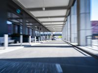 blurred photograph of a train station with cars moving by at high speed and blurry