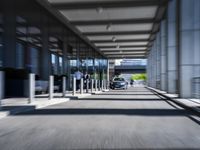 blurred photograph of a train station with cars moving by at high speed and blurry