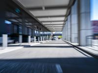 blurred photograph of a train station with cars moving by at high speed and blurry