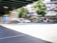 a blurry image of a bike riding down the street in front of a building