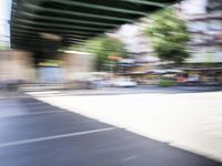 a blurry image of a bike riding down the street in front of a building