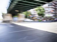 a blurry image of a bike riding down the street in front of a building