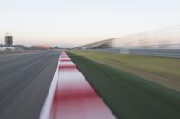 motion blurry of an asphalt race track as a motorcycle glides along the road