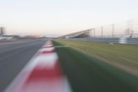 motion blurry of an asphalt race track as a motorcycle glides along the road