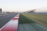 motion blurry of an asphalt race track as a motorcycle glides along the road