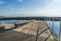 a wooden dock near the ocean in the day time - stock photo - images and pictures