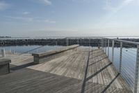 a wooden dock near the ocean in the day time - stock photo - images and pictures