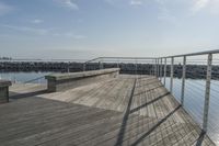 a wooden dock near the ocean in the day time - stock photo - images and pictures