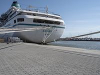 the bow of a boat at dock with docked boats in the background for shipping services