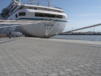 the bow of a boat at dock with docked boats in the background for shipping services