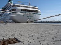 the bow of a boat at dock with docked boats in the background for shipping services