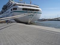 the bow of a boat at dock with docked boats in the background for shipping services