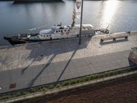 the boat is docked in the harbor next to the water dock with benches on it