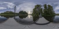 this is the 360 - time view of a boathouse on a river, with the sun behind a sky line