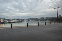 several boats are anchored at the marina with traffic cones along side of the river water