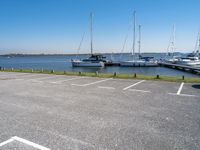 several boats are docked on the water next to the shore line of the marinas