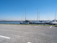 several boats are docked on the water next to the shore line of the marinas